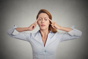 Portrait of concentrating woman isolated on grey wall background.